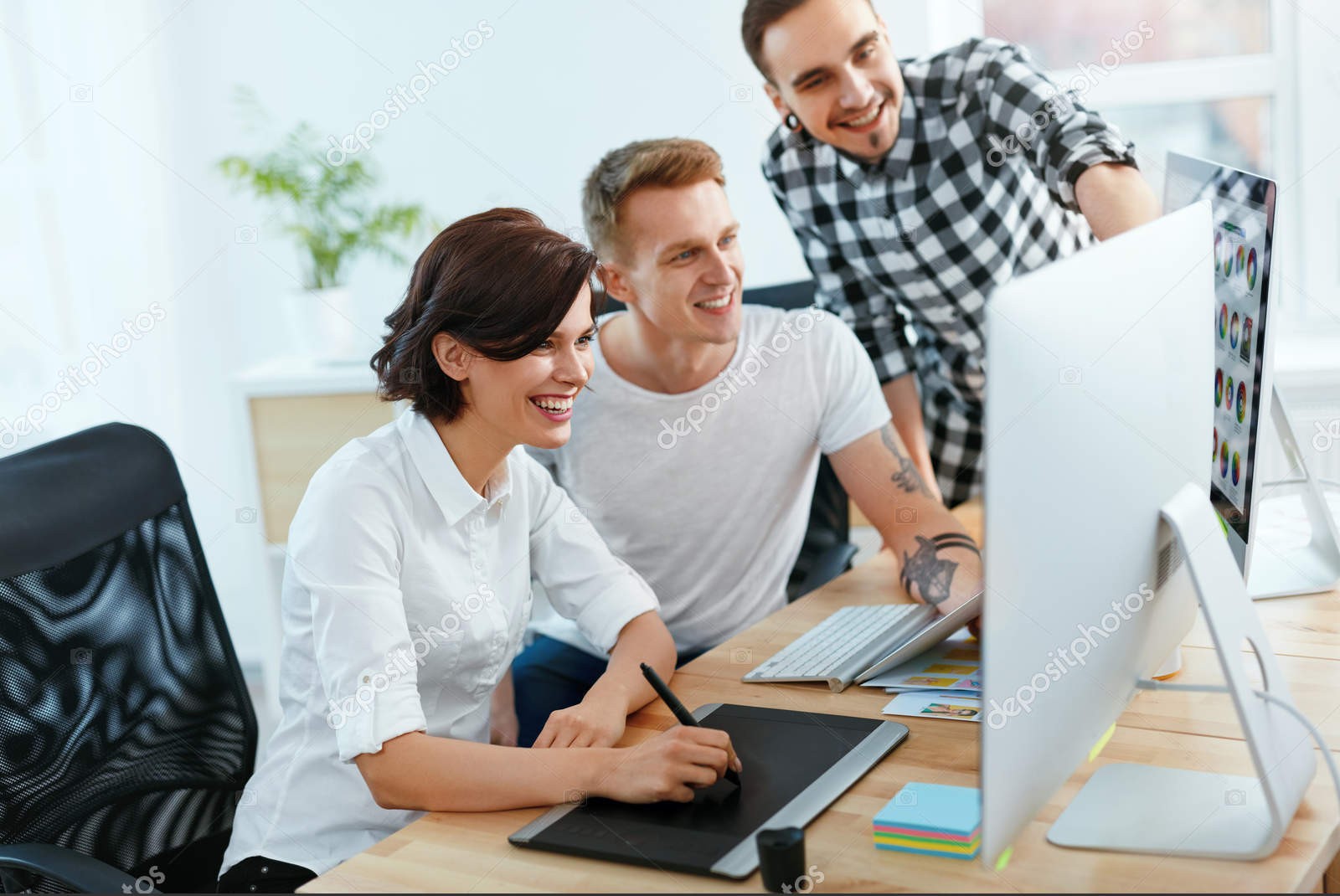 Team Of People Working On Computer In Office