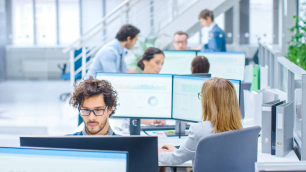 Big Busy Corporate Office with Two Rows off Businessmen and Businesswomen Working on Desktop Computers. Bright Open Space Office with Businesspeople and Salespeople